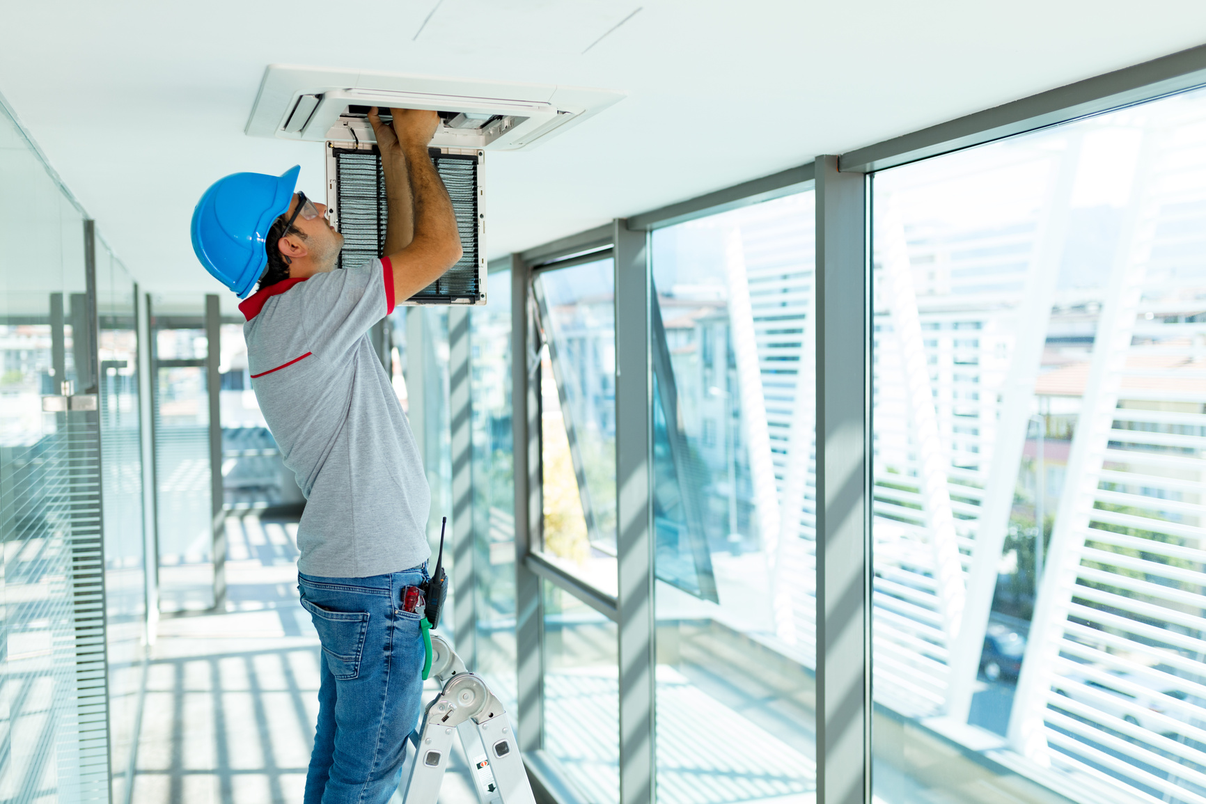 Worker installing air conditioner